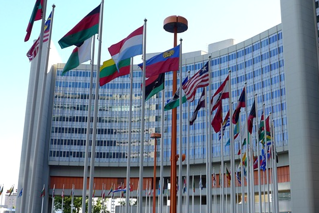United Nations building with multiple national flags, representing global climate negotiations and China’s growing diplomatic role at COP30.