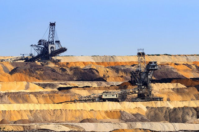 Coal piles at a power facility in China illustrating declining coal plant approvals and changing energy strategy.