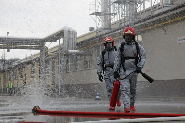 Two technicians in hazmat suits monitoring ammonia handling procedures, highlighting safety and industrial challenges in scaling green ammonia technologies.