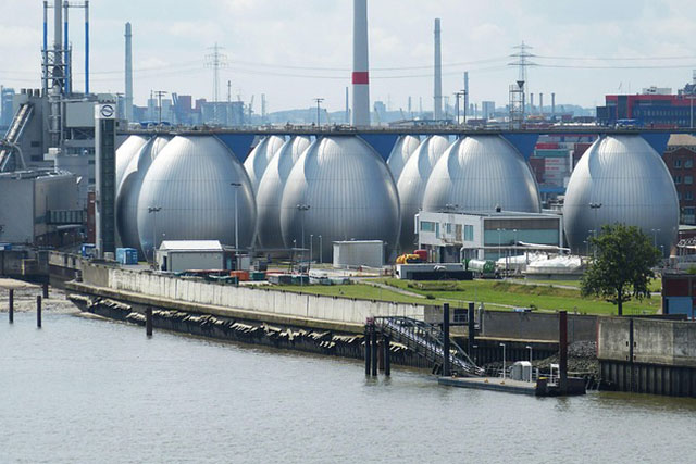 Large water treatment facility with multiple tanks, pipes, and industrial buildings.